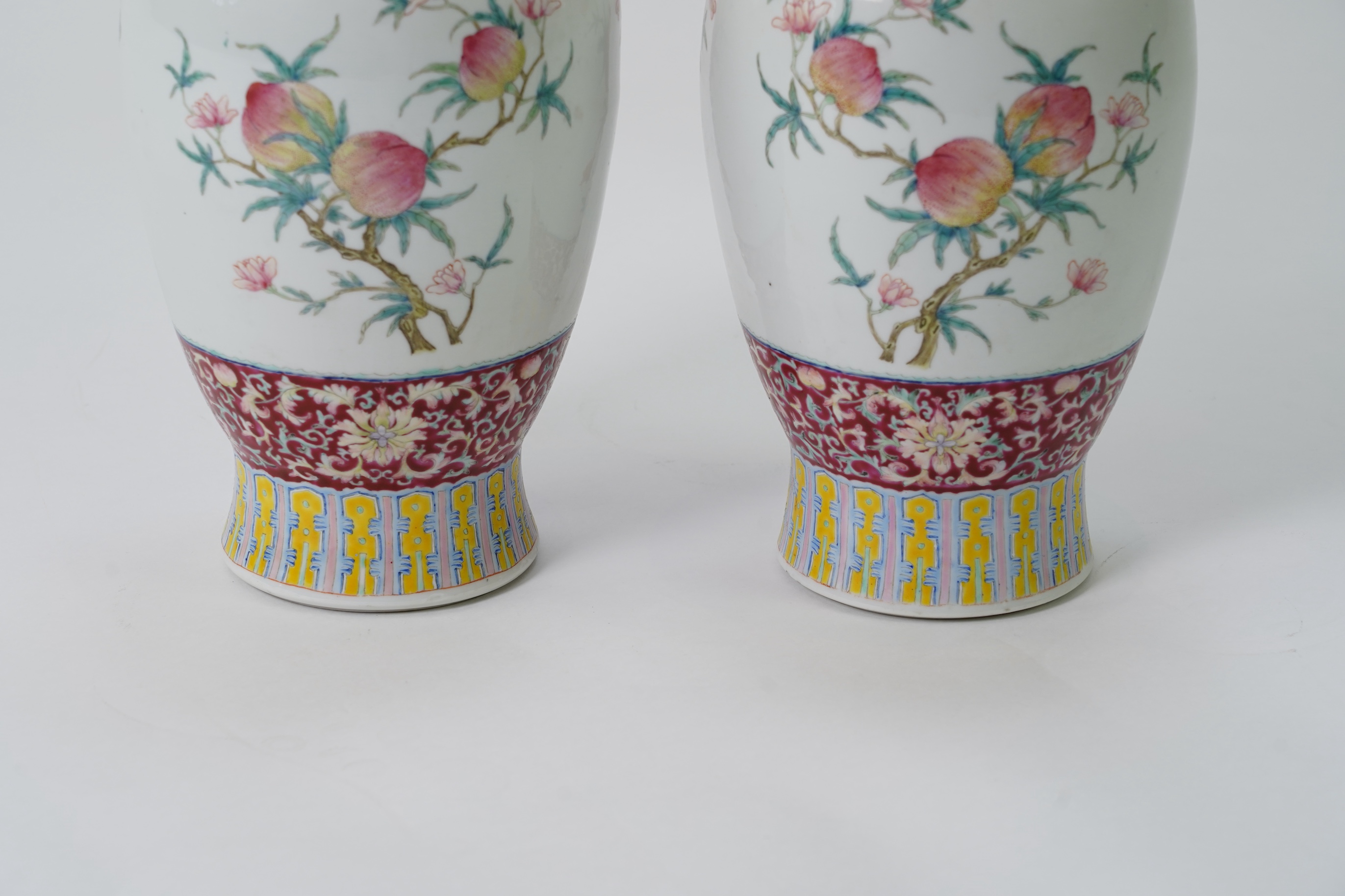 A pair of Chinese famille rose ‘sanduo’ vases, Qianlong seal mark, 19th century